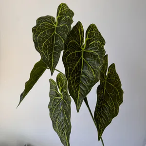 Close-up of 3D printed artificial Caladium leaves with realistic green and yellow veins.