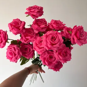 Detailed view of large pink silk roses bouquet featuring realistic water droplets