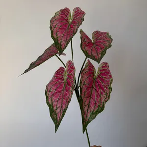 Close-up of 3D printed artificial Caladium leaves with vibrant pink and green patterns