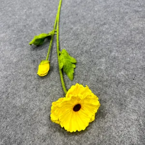 Close-up of a yellow artificial poppy flower with realistic petal texture and bud.