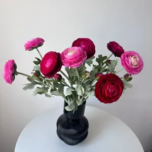 Elegant artificial pink and red ranunculus flowers arranged in a black textured vase.