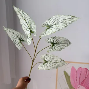 Close-up detail of artificial white caladium leaves with realistic green vein patterns for decor