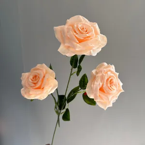 Realistic detail of champagne artificial rose heads featuring delicate water droplets on petals.