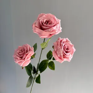 Detailed macro view of three pink artificial roses with realistic water droplets