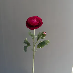 Close-up of a deep red artificial Ranunculus flower with a delicate bud on a green stem.