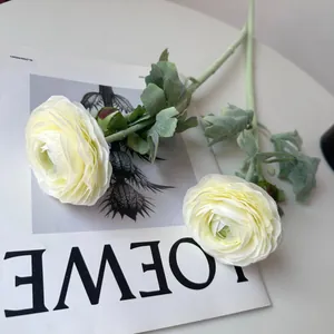 Detailed view of white artificial Ranunculus flowers with realistic flocked green stems.