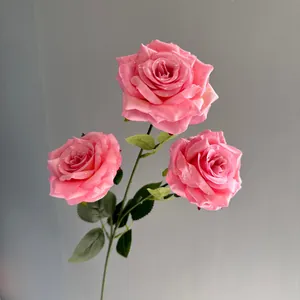 Detailed view of three-head artificial pink roses featuring realistic water droplets