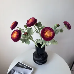 Elegant flocked dark purple Ranunculus artificial flowers in a black ribbed vase