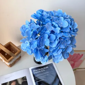 Detailed view of vibrant blue artificial hydrangea petals in a Monet garden style