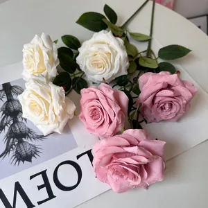 Detailed close-up of artificial pink and white roses with realistic water droplets