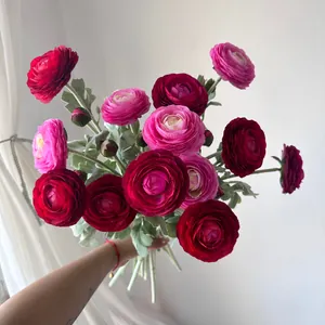 Detailed view of hand-held bouquet with vibrant pink and red silk Persian Buttercups