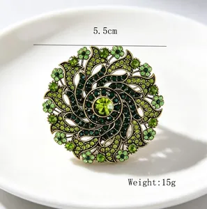 Close-up view of a vintage alloy wreath brooch with green rhinestones, 5.5cm diameter