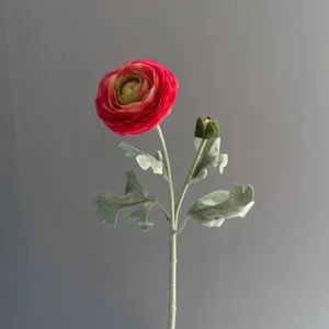 Close-up of realistic red flocked ranunculus artificial flower with green bud