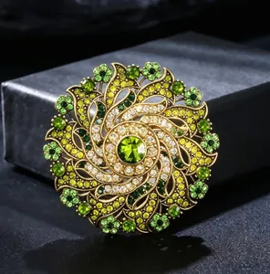 Close-up of vintage luxury crystal flower brooch with green and yellow rhinestones.