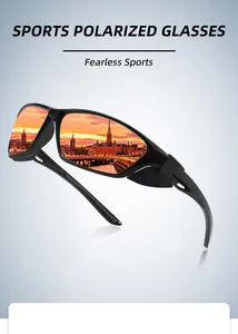 Close-up of black polarized sports sunglasses featuring a golden sunset city reflection