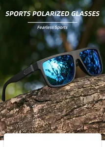 Close-up of polarized sports sunglasses with blue mirrored lenses on a tree trunk.