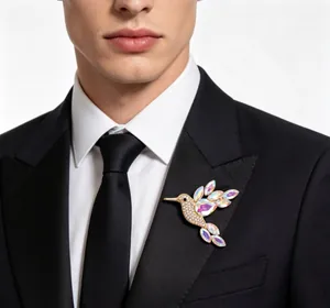 Close-up of a sparkling hummingbird brooch with iridescent stones on a black suit lapel