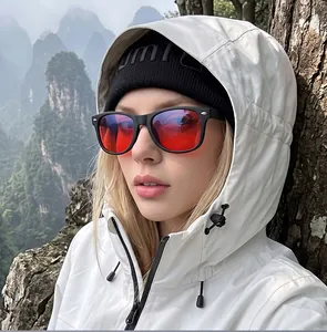Fashionable retro sunglasses with striking red lenses worn by model in outdoor setting