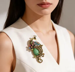 Detailed close-up of vintage peacock brooch with colorful rhinestones on a white vest