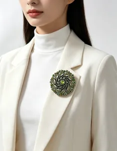 Exquisite vintage green crystal wreath brooch pinned on a stylish white blazer