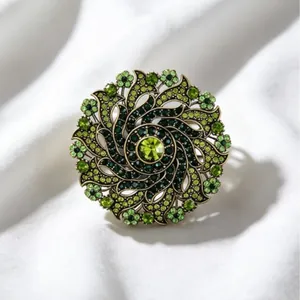 Elegant vintage green rhinestone wreath brooch with luxury spiral floral design