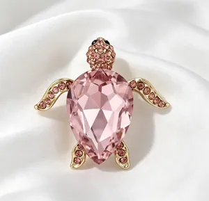 Gros plan détaillé d'une broche tortue élégante ornée d'un grand cristal rose facetté