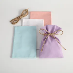 Set of colorful canvas drawstring pouches in pastel shades for jewelry gift packaging