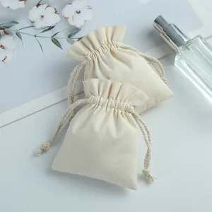 Macro view of natural cream cotton drawstring pouch for jewelry storage and gift packaging