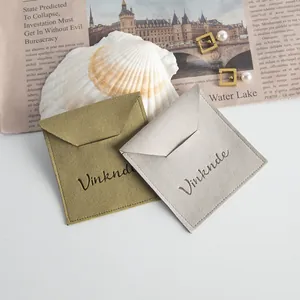 Close-up of microfiber jewelry pouches with envelope flaps in olive and grey