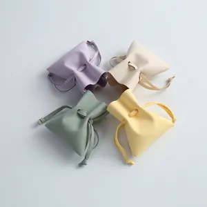 Four pastel microfiber drawstring jewelry pouches for organizing small accessories