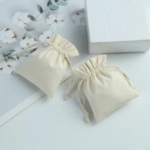 Close-up of natural cotton drawstring pouches for jewelry packaging and storage.