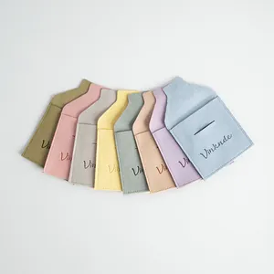 Detailed view of microfiber jewelry pouches in various pastel colors with envelope closure