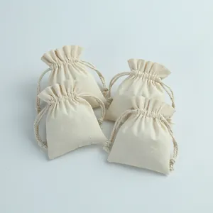 Four small off-white cotton drawstring pouches for jewelry storage and packaging