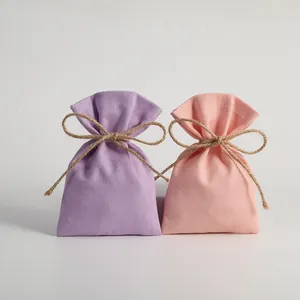 Pair of colorful cotton drawstring gift pouches decorated with rustic hemp rope bows