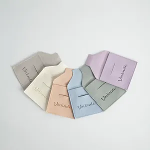 Detailed view of colorful microfiber jewelry pouches with elegant envelope flap design