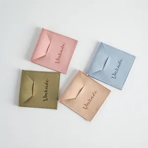 Detail of microfiber envelope pouches in pink, blue, olive, and peach colors for jewelry storage.