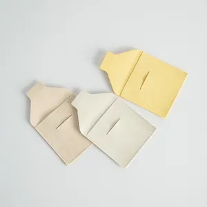 Close-up of microfiber jewelry pouches in yellow, beige and cream with envelope flap.