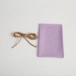 Detailed view of a light purple velvet drawstring pouch and a natural hemp rope bow