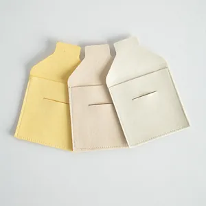 Detail view of soft microfiber jewelry pouches with elegant envelope flap design.