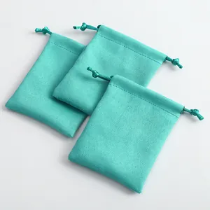 Vista detallada de bolsas de gamuza turquesa con cordón para empaque de joyería