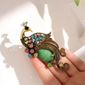 Vintage elegant peacock brooch with colorful rhinestones and green turquoise-style stone
