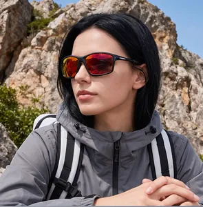 Polarized sports sunglasses with red mirrored lenses worn by a hiker in an outdoor rocky setting