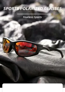 Close-up of sports polarized sunglasses with orange-red reflective lenses on black leather.