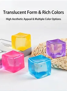 Close-up of four colorful 5.5cm translucent maltose ice cube squishy toys on a desk