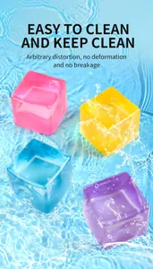 Macro detail of four colorful maltose squishy ice cubes floating on crystal water ripples