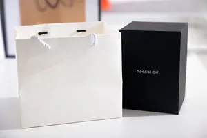 Elegant white embossed gift bag and black minimalist gift box for special presents