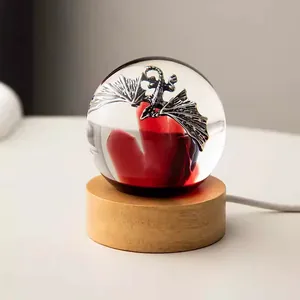Detailed view of crystal ball night light featuring an intricate dragon figurine