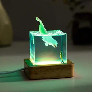 Detailed view of ocean whale resin night light with glowing diver effect