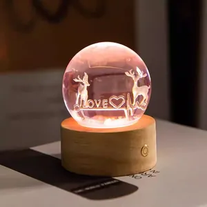 Detailed view of 3D engraved deer crystal ball night light on a wooden base