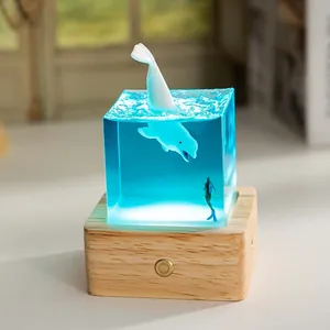 Detailed view of ocean resin cube night light featuring whale and diver landscape